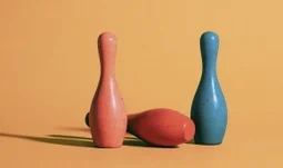 bowling pins, one has fallen over 