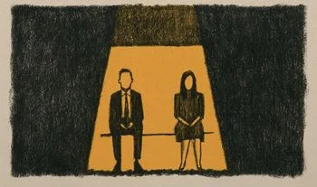 A man and a woman sitting in a golden light 